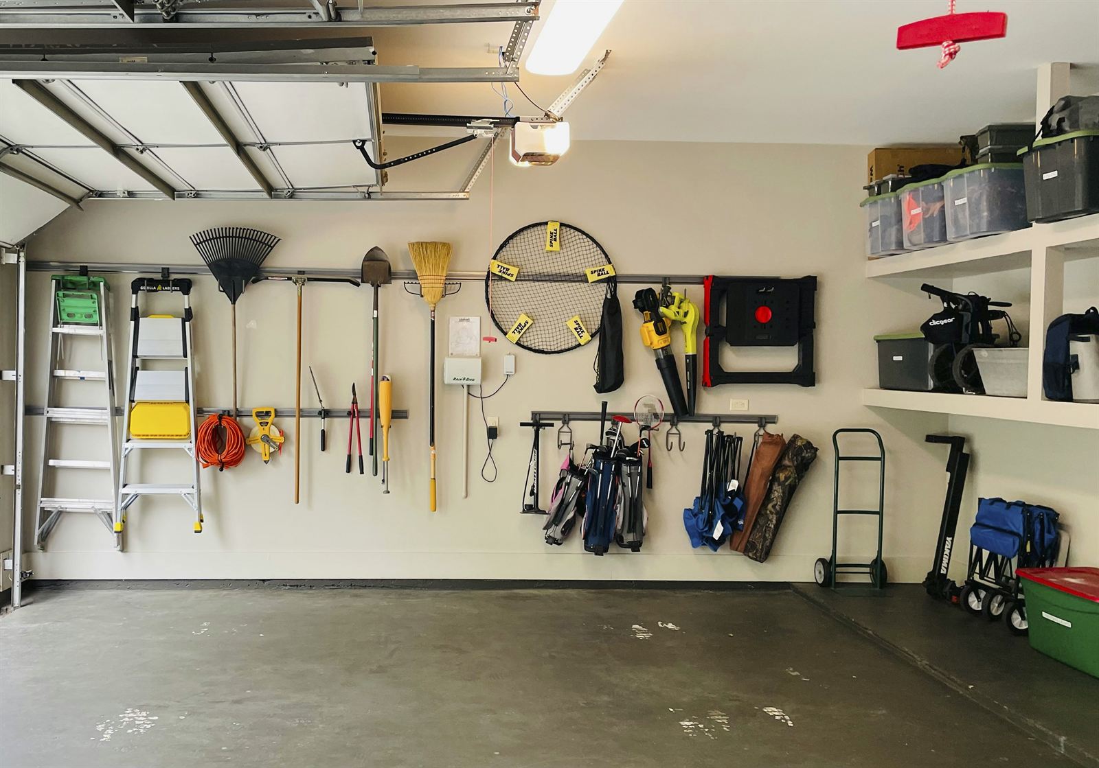 Organized small garage with affordable storage solutions for tools, household supplies, and other garage essentials. Organized small garage with affordable storage solutions for tools, household supplies, and other garage essentials.