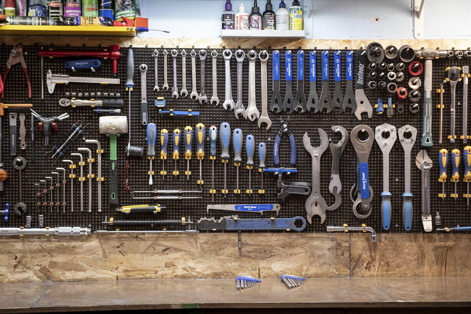 Organized garage tool wall with wrenches, screwdrivers, sockets, and other hand tools stored on a space-saving pegboard. Organized garage tool wall with wrenches, screwdrivers, sockets, and other hand tools stored on a space-saving pegboard.