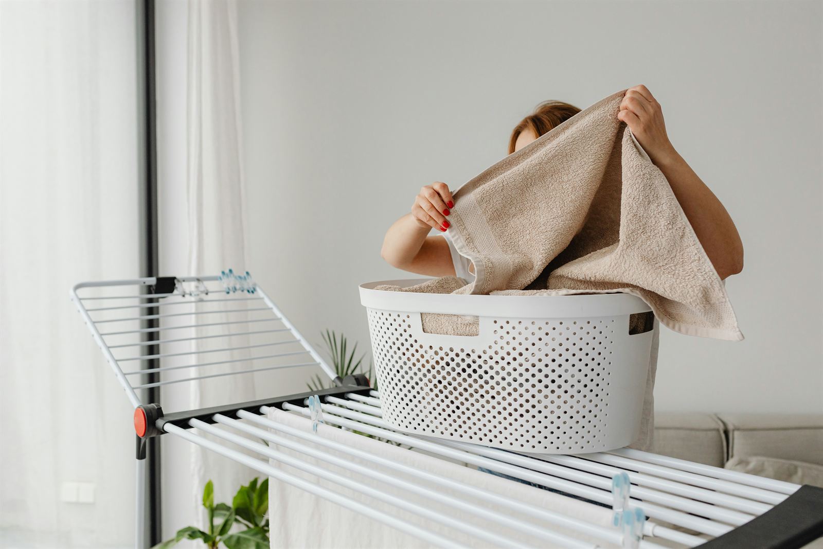 Organized laundry room with a laundry basket and drying rack for practical laundry room storage and organization. Organized laundry room with a laundry basket and drying rack for practical laundry room storage and organization.